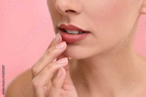 Woman with beautiful lips on pink background  closeup