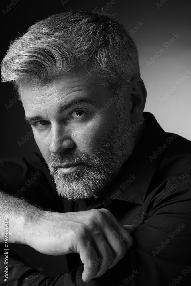 Portrait of handsome man on dark background. Black and white effect Portrait of handsome man on dark background. Black and white effect