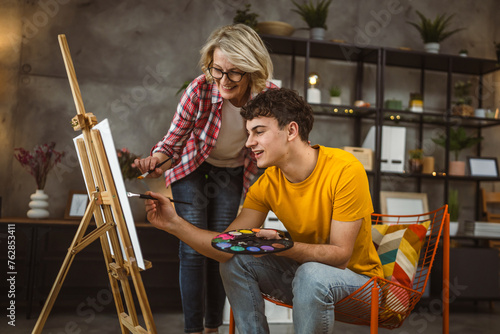 mother and son paint at home mentor artist help teach to create art