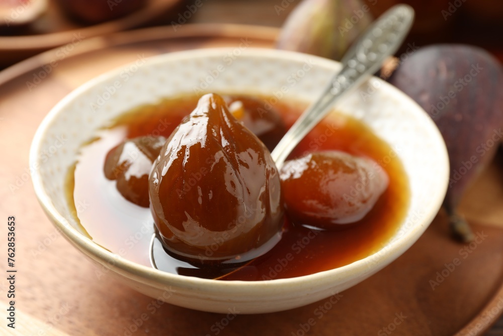 Bowl of tasty sweet fig jam on wooden table, closeup Bowl of tasty sweet fig jam on wooden table, closeup