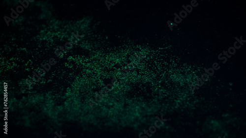 Abstract dark background with green spots.  © Champ