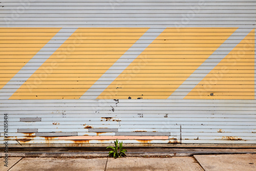 Horizontal View of Closed Grey Garage Door with Yellow Diagonal Stripes