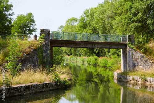 Narrow Bridge Over a Calm River