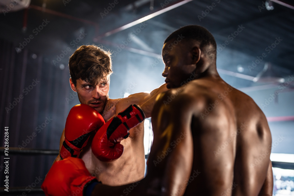 Two young professional boxer having a competition tournament on stage. 