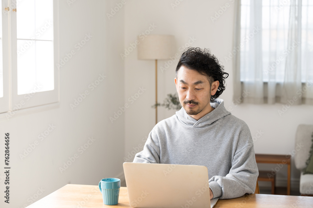 Image of Asian (Japanese) men who telework and work or use computers at home. Image of Asian (Japanese) men who telework and work or use computers at home.