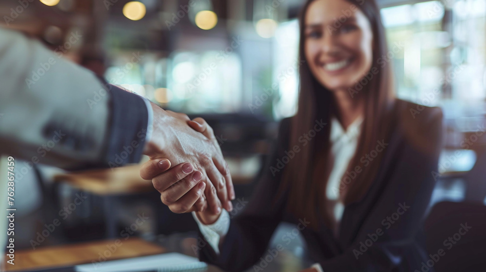 business man and woman are shaking hands in office