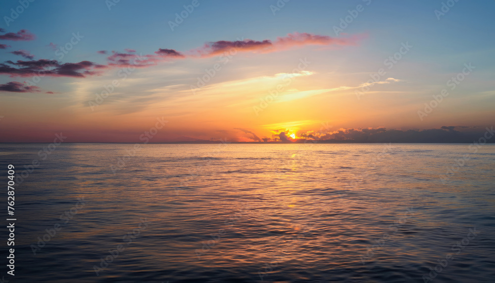 Beautiful sunset over the calm surface of the ocean