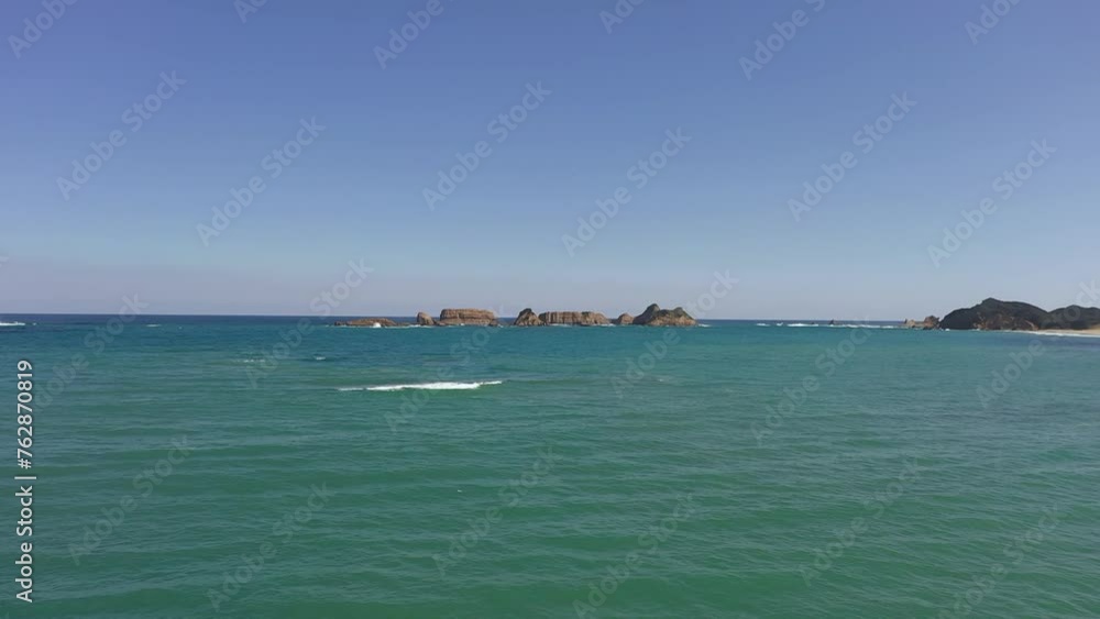 Drone heading for rocks above the sea.
Blue sky and beautiful ocean. Drone heading for rocks above the sea.
Blue sky and beautiful ocean.