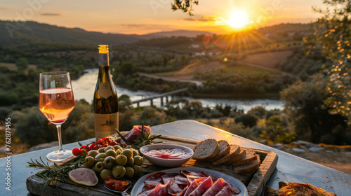 You take in the stunning view of the sunset over the river sipping on a glass of cold crisp rosé and nibbling on a savory picnic of cured meats olives and crusty bread. photo