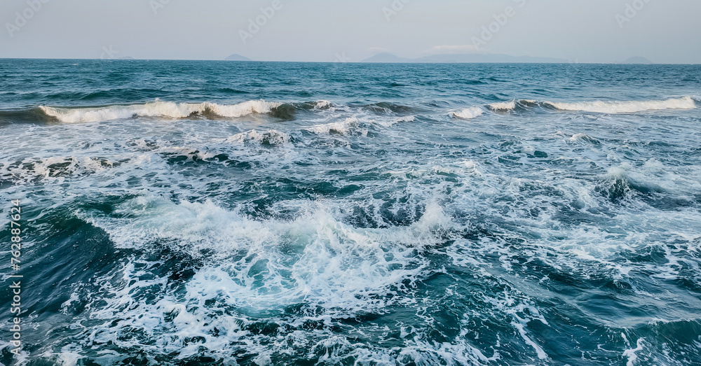 Vast ocean waves under a clear sky, ideal for backgrounds and nature-themed designs, with ample copy space for text overlay
