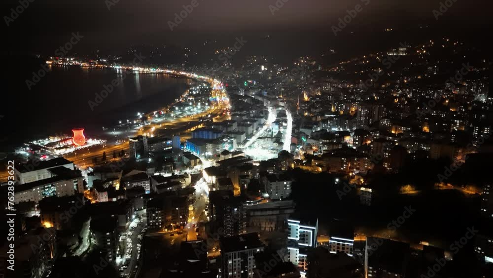 night time view of a city with a river and a bridge night time view of a city with a river and a bridge