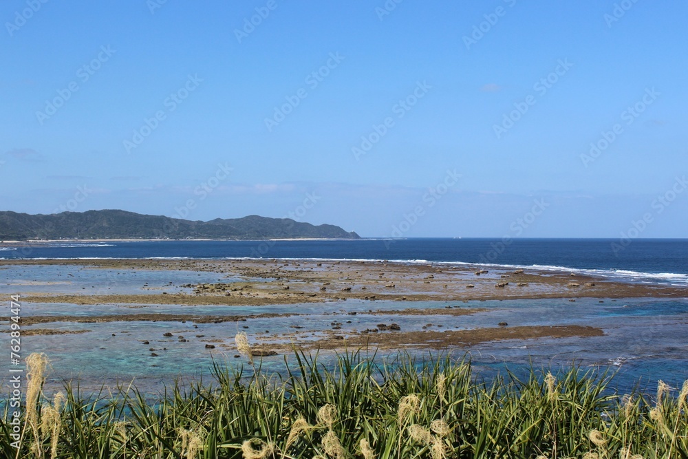 A panoramic view of Pacific Ocean, reefs, and Kasari Town in Amami Oshima Island