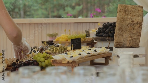 A table with assorted cheeses  fruits  a festive table  a table with food for events. Cheese tasting. Table with hard cheeses camembert  brie  parmesan  dutch cheese.