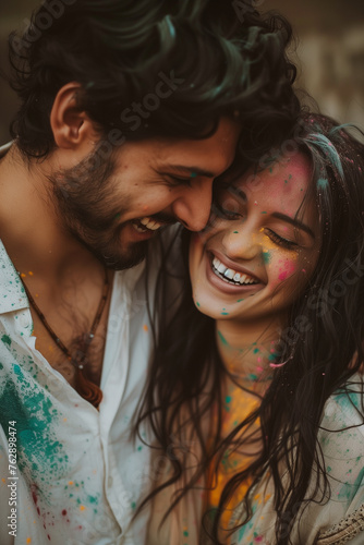 Joyful couple sharing laughter at colorful holi festival celebration