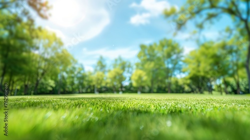 Beautiful blurred background image of spring nature with a neatly trimmed lawn surrounded by trees against a blue sky with clouds on a bright sunny day : Generative AI
