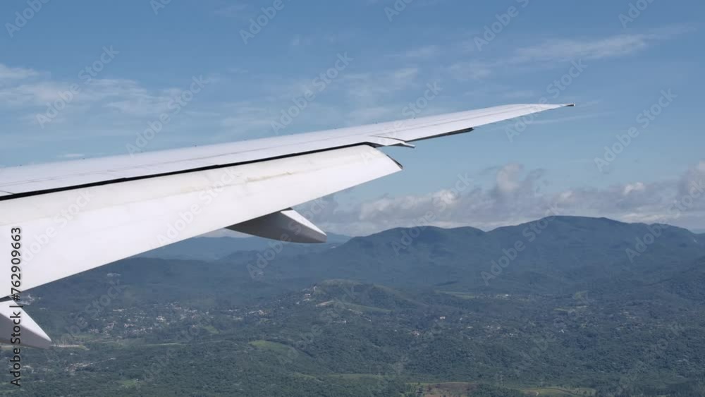 Extended Flaps on Aircraft Wing Preparing for Landing, View from Cabin Extended Flaps on Aircraft Wing Preparing for Landing, View from Cabin