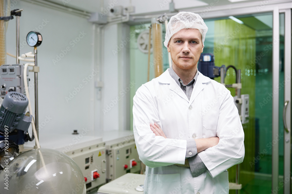 scientist smiling and folded arms pose in testing lab