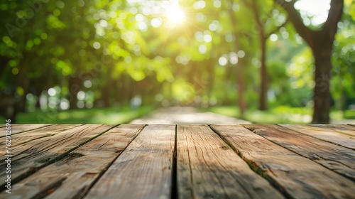 Empty rustic wooden texture of old wood table top blur against green park with defocused sunlight blurred foliage backyard background Display mock up montage your product design key vi : Generative AI