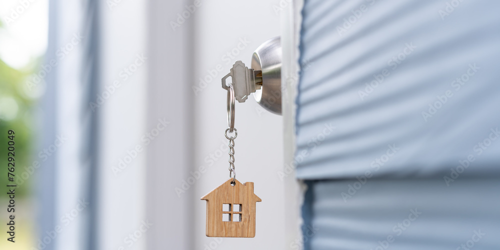 Landlord key for unlocking house is plugged into the door. Second hand house for rent and sale. keychain is blowing in the wind. mortgage for new home, buy, sell, renovate, investment, owner, estate Landlord key for unlocking house is plugged into the door. Second hand house for rent and sale. keychain is blowing in the wind. mortgage for new home, buy, sell, renovate, investment, owner, estate