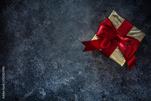 Gold Wrapped Gift Box With Red Ribbon