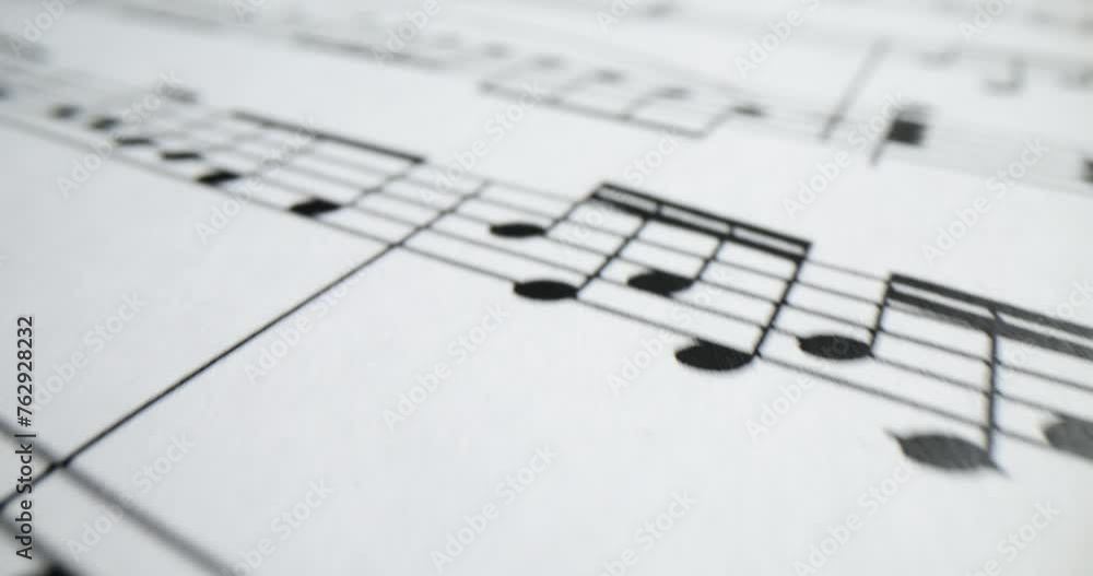 Melody written with note signs on white music sheet Melody written with note signs on white music sheet