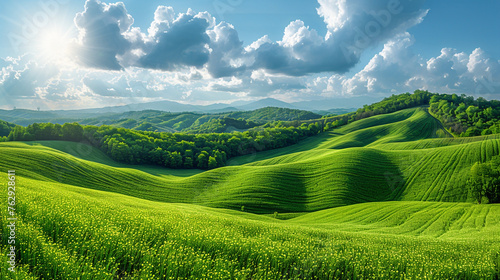 Wide wallpaper background image of long empty grass mountain valley landscape with beautiful greenish grass field and blue sky with white clouds 