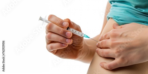 Caucasian woman self-administering insulin injection into her abdomen subcutaneously, emphasizing diabetes treatment, isolated on white background for medical concept. photo