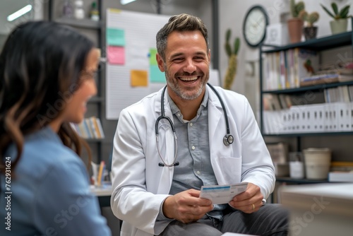 Friendly doctor smiling at patient while holding prescription in clinic, concept of positive healthcare experience and trust