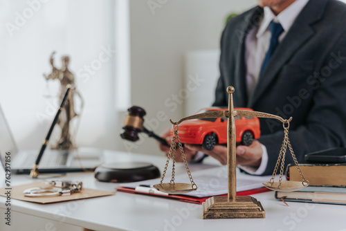 Judge male hand with car and documents and hammer