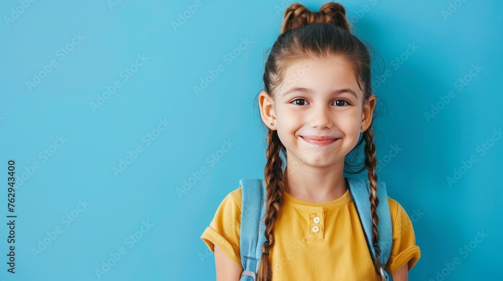 little girl smiling on a blue background, concept back to school, learning, free text and copy space, 16:9 little girl smiling on a blue background, concept back to school, learning, free text and copy space, 16:9