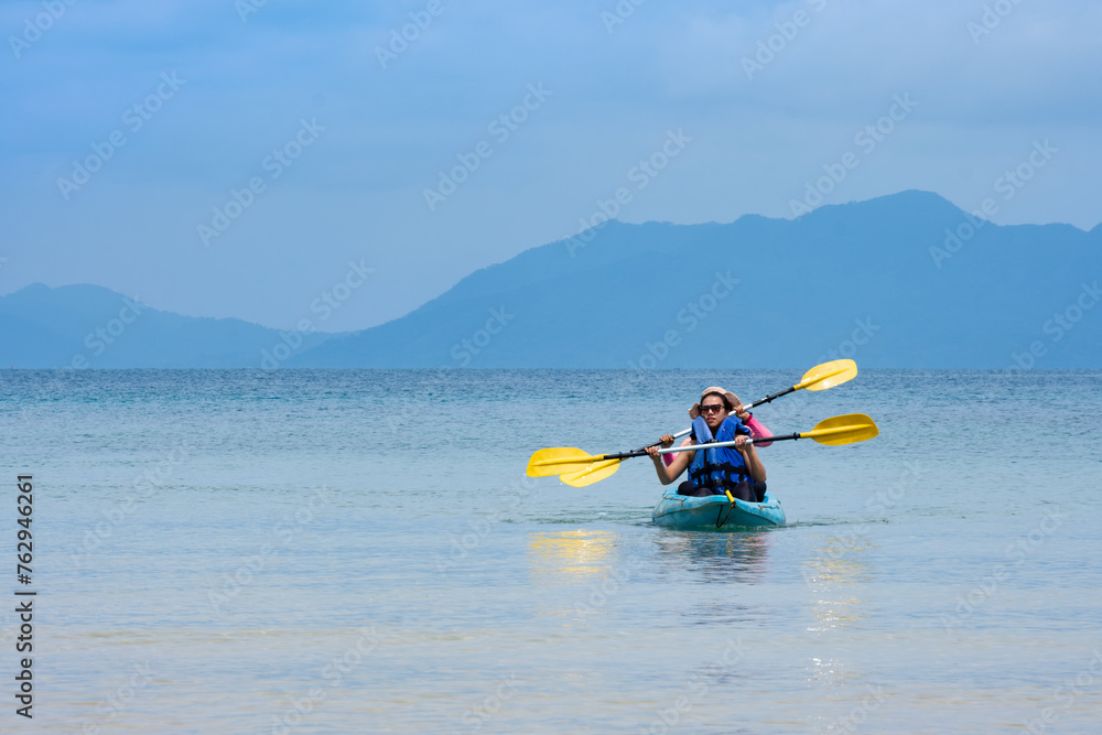  kayak in the blue sea .Woman kayaking She does water sports activities	