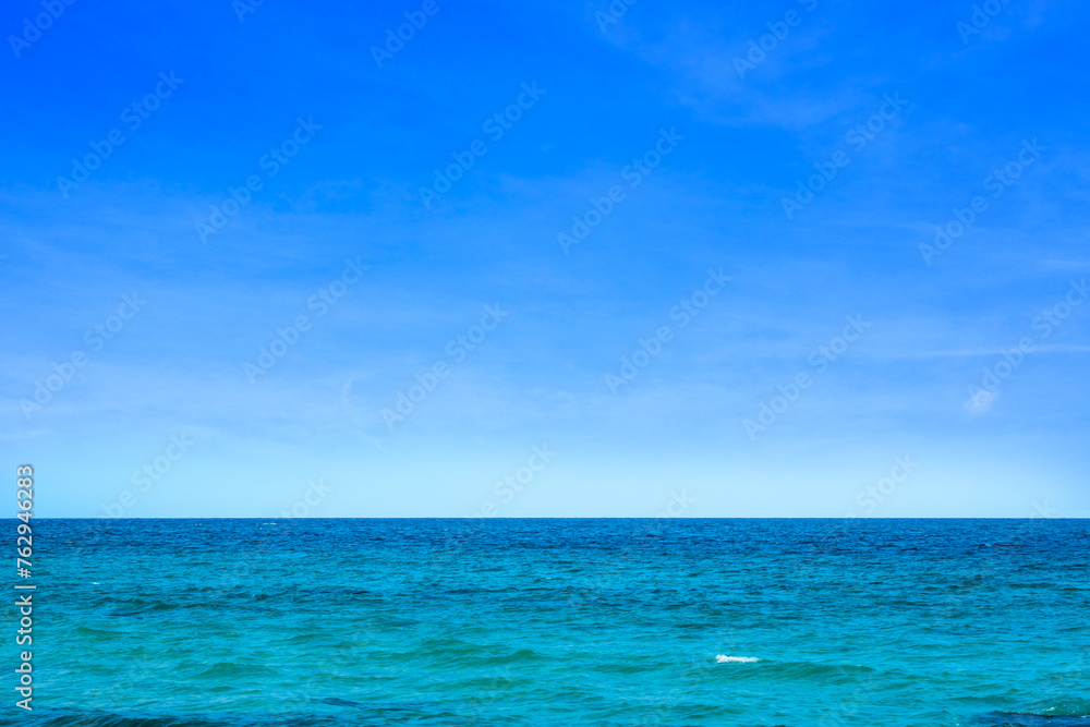 Ocean background and sea water and clear sky. For summer vacation ideas The nature of the beach and summer sea with the sun shining on the sea sparkling against the blue sky.	
