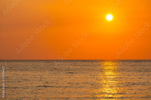 Sea view for summer vacation concept Nature of the summer beach and sea with soft sunlight. hitting the sand The sea sparkles against the sunset sky.