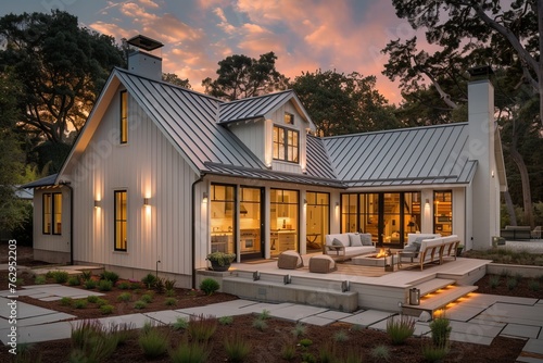 Modern farmhouse with gabled roof constructed by board and batten. photo
