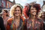 Two women with red hair and colorful clothing are smiling and posing for a photo