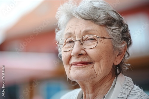 A woman with glasses is smiling