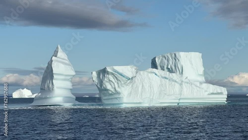 An iceberg after a piece of it has fallen into the sea in Hall Bredning. Scoresbysund, Greenland. photo