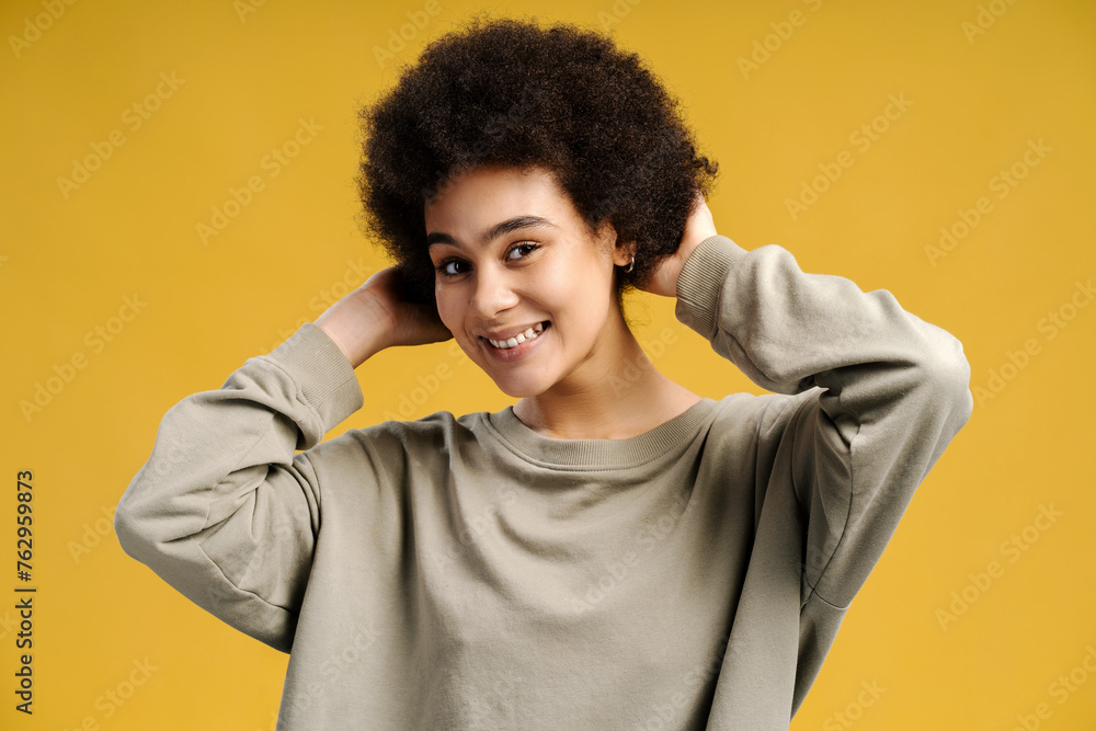 Happy authentic african american woman, fashion model with curly hair looking at camera Happy authentic african american woman, fashion model with curly hair looking at camera