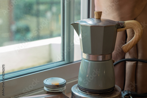 Moka Pot, Coffee pot for brewing coffee on a wooden table. Relax with a cup of coffee in the morning