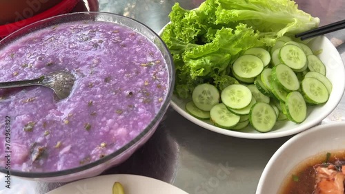 Vietnamese dinner on the table rice pickles cucumbers salad Fish with dark beans in spicy sauce Taro Vietnamese purple soup with vegetables  photo