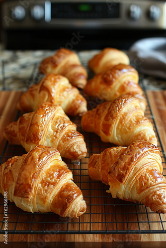 Freshly baked croissants on cooling rack photo