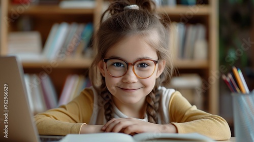 Cute little schoolgirl in vision glasses doing her homework in a home environment. A child at a desk in a children's room gains knowledge