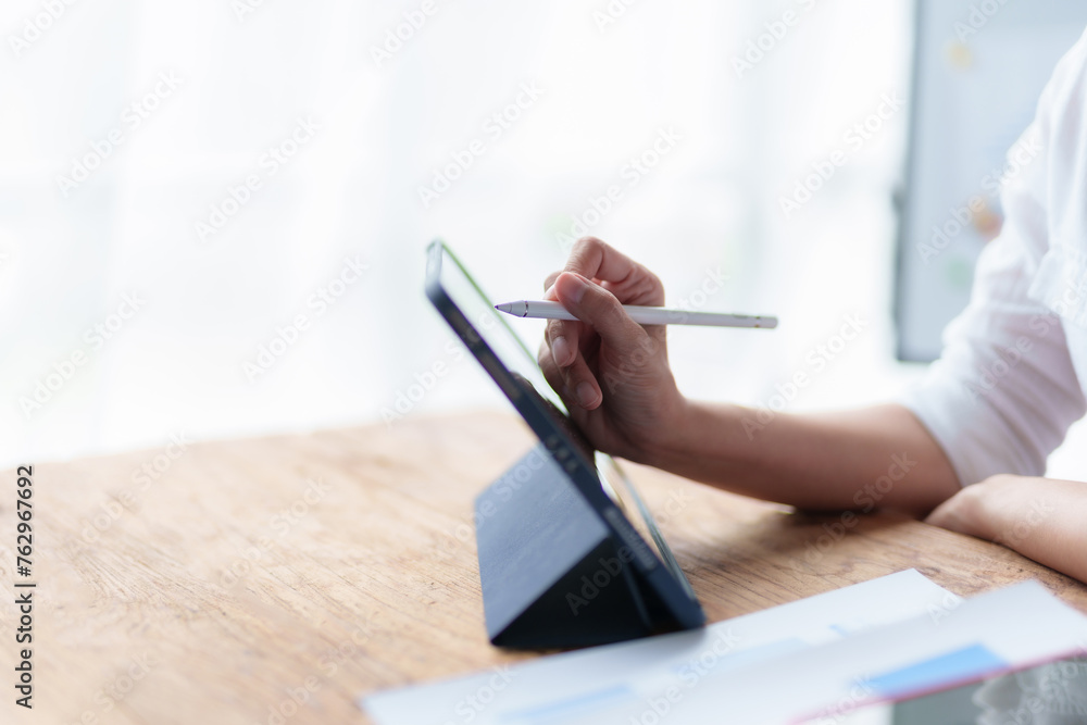 Person using stylus on digital tablet for creative project. Technology and digital art concept. Person using stylus on digital tablet for creative project. Technology and digital art concept.