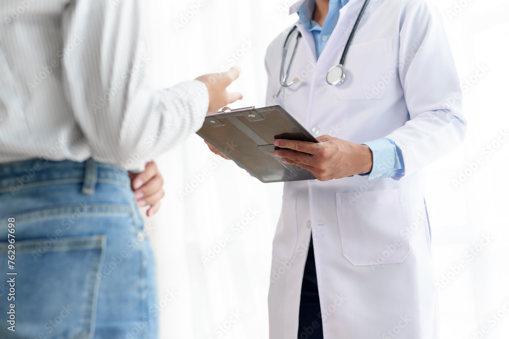 Doctor with clipboard discussing health concerns with patient. Medical consultation and healthcare concept. Doctor with clipboard discussing health concerns with patient. Medical consultation and healthcare concept.