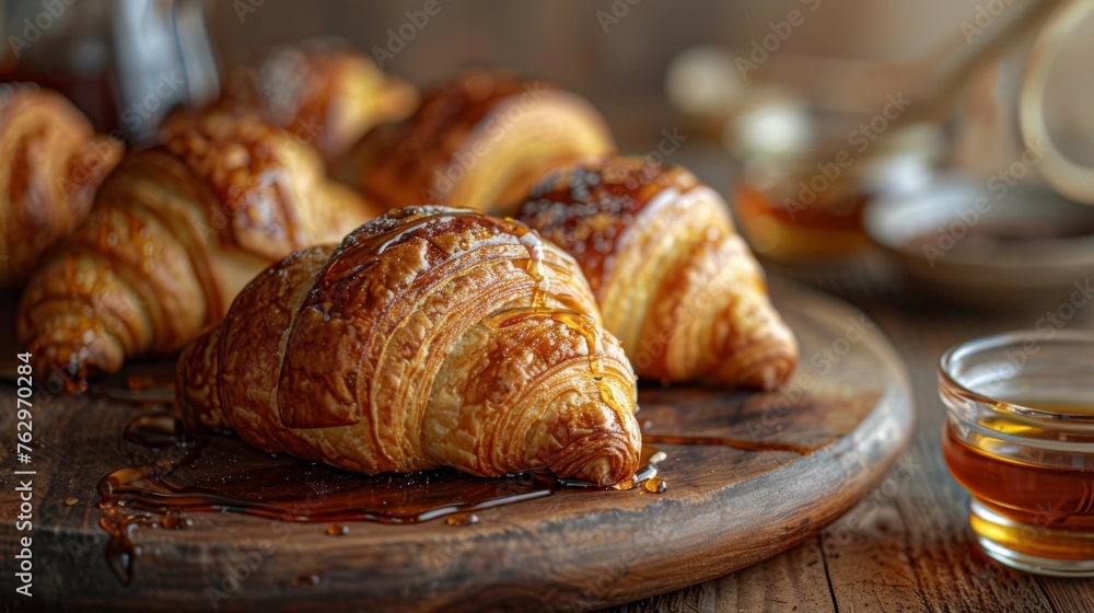 Delectable Croissants on Wooden Plate With Syrup