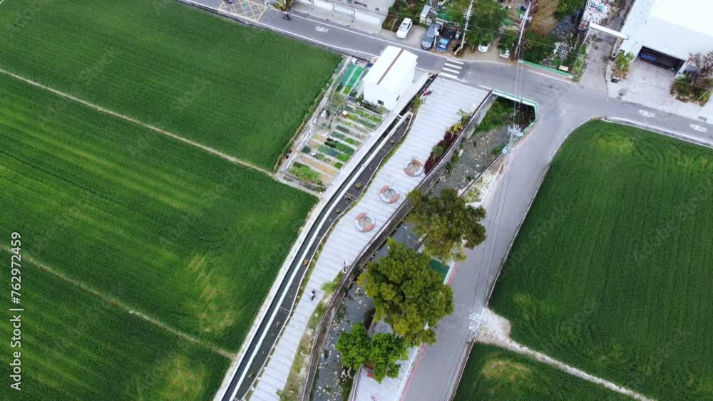 A sprawling suburban landscape with fields under blue skies, aerial view A sprawling suburban landscape with fields under blue skies, aerial view