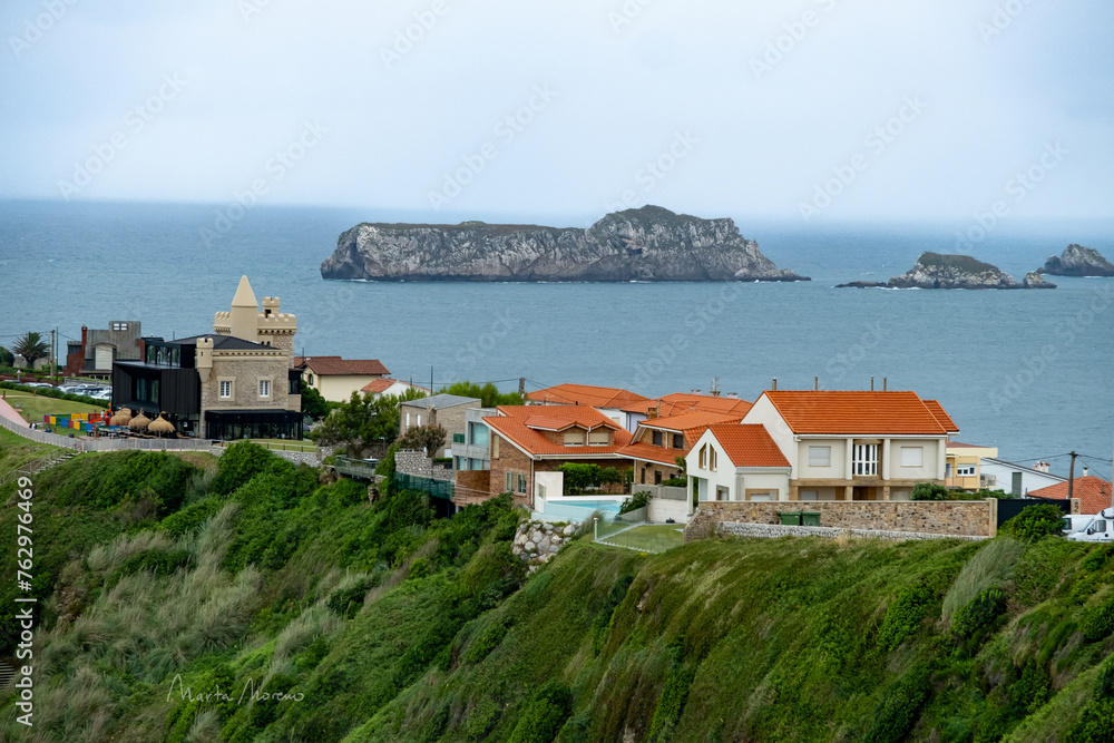 Fototapeta premium Scenic Coastal Town in Cantabria with Houses Overlooking the Sea