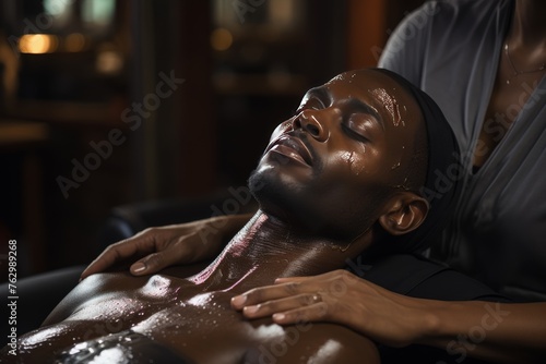 Man Receiving Facial Massage From Woman