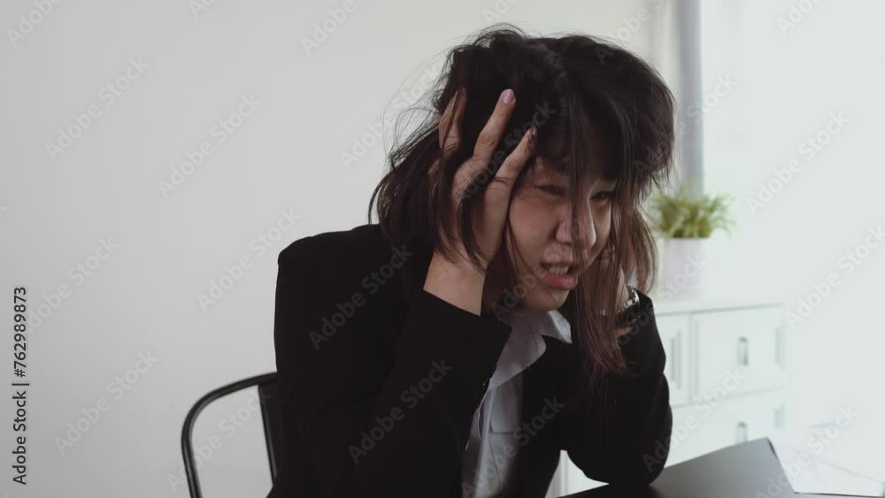 Asian business woman is tired and stressed from working on financial accounting. Asian business woman is tired and stressed from working on financial accounting.