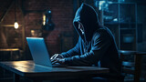 A mysterious hacker thief sits at a computer